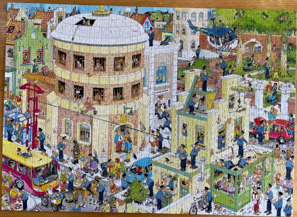 A busy cartoon illustration of a bustling police station and city street scene filled with numerous characters.