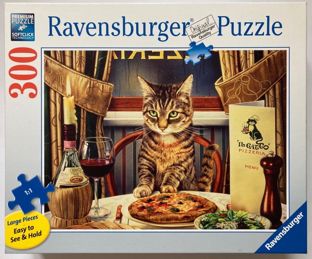A tabby cat sits at a restaurant table with a pizza, red wine, and a menu.
