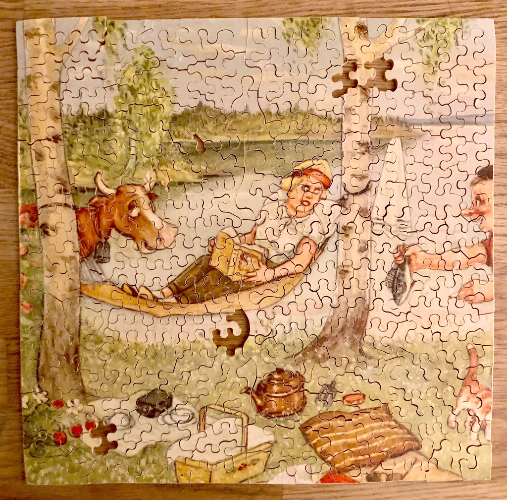 Vintage picnic scene with a boy, cow, and river.