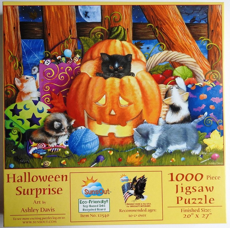 A Halloween scene featuring several kittens playing with a jack-o'-lantern, trick-or-treat bags, and candy.