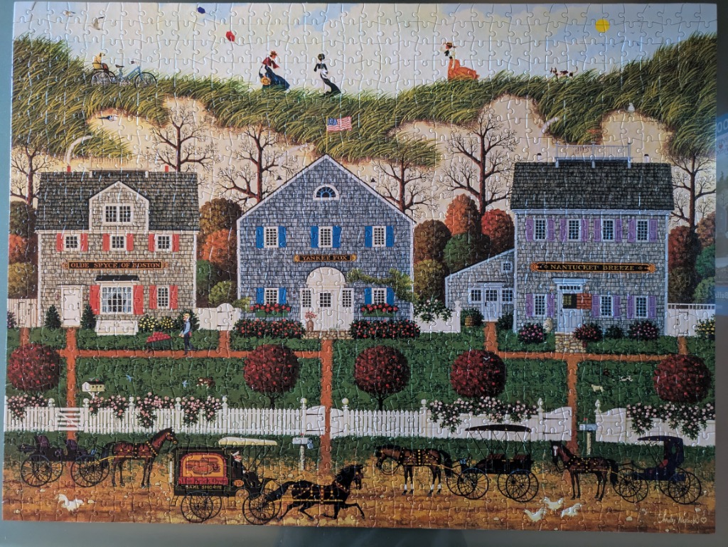 Folk art style painting of three coastal houses with horse-drawn carriages in front and grassy dunes behind.