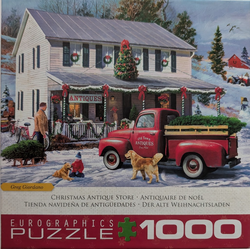 A snowy winter scene with a vintage red pickup truck parked in front of an antique store decorated for Christmas.