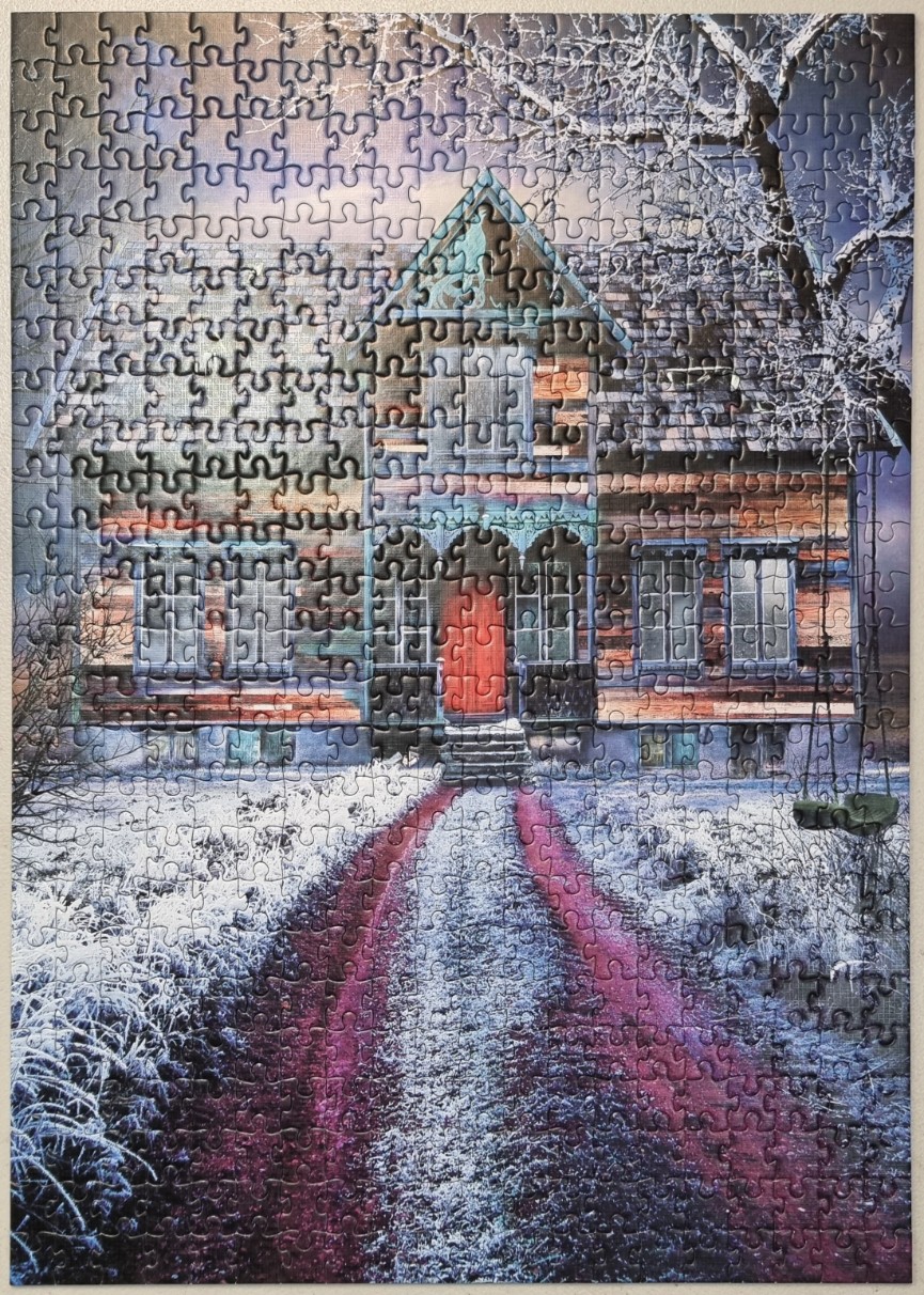 An old wooden farmhouse at the end of a long path covered in snow under a twilight sky.