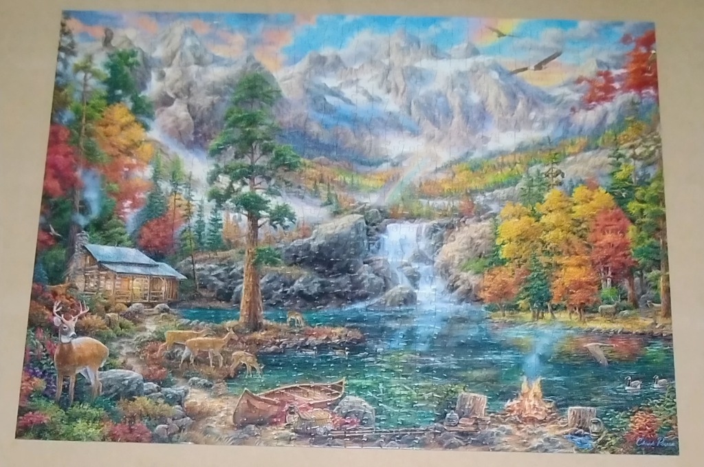 A peaceful landscape painting of a mountain lake, cabin, waterfall, and deer in autumn colors.