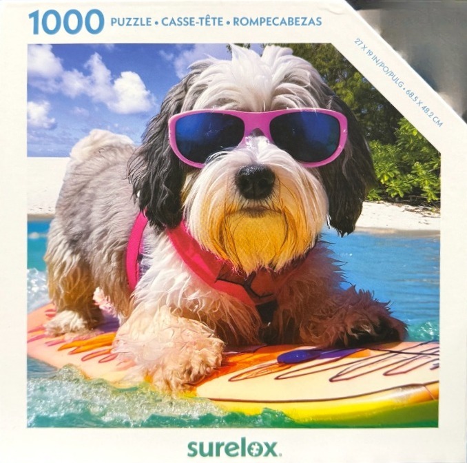 A shaggy dog wearing bright pink sunglasses and a life vest standing on a yellow surfboard in the ocean.