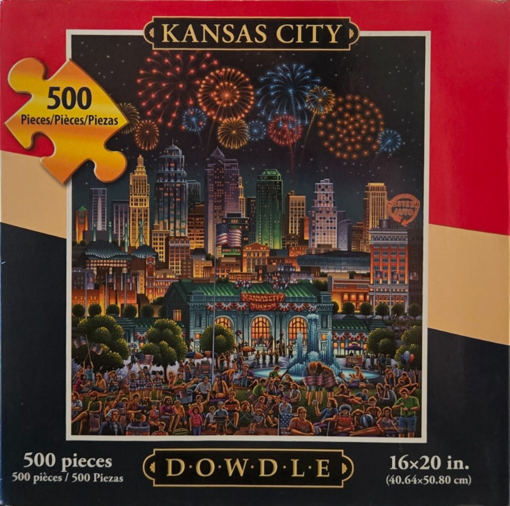 A nighttime scene of Kansas City with fireworks over the skyline and a crowd gathered in front of Union Station.