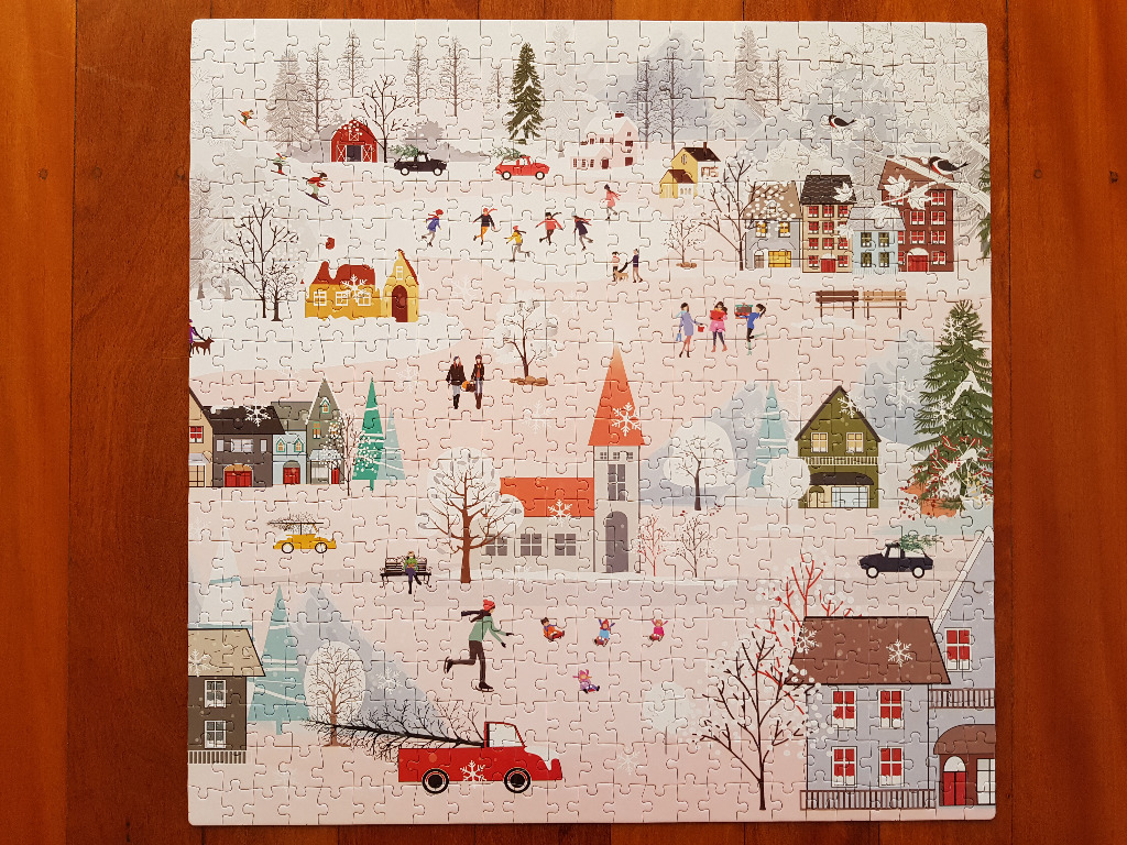 A whimsical illustration of a snowy winter village scene with people skating and carrying Christmas trees.
