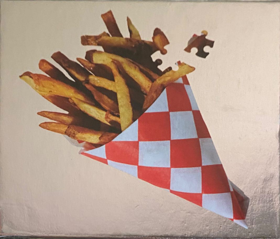 A cone of golden french fries against a metallic gold background, with a single puzzle piece floating above.