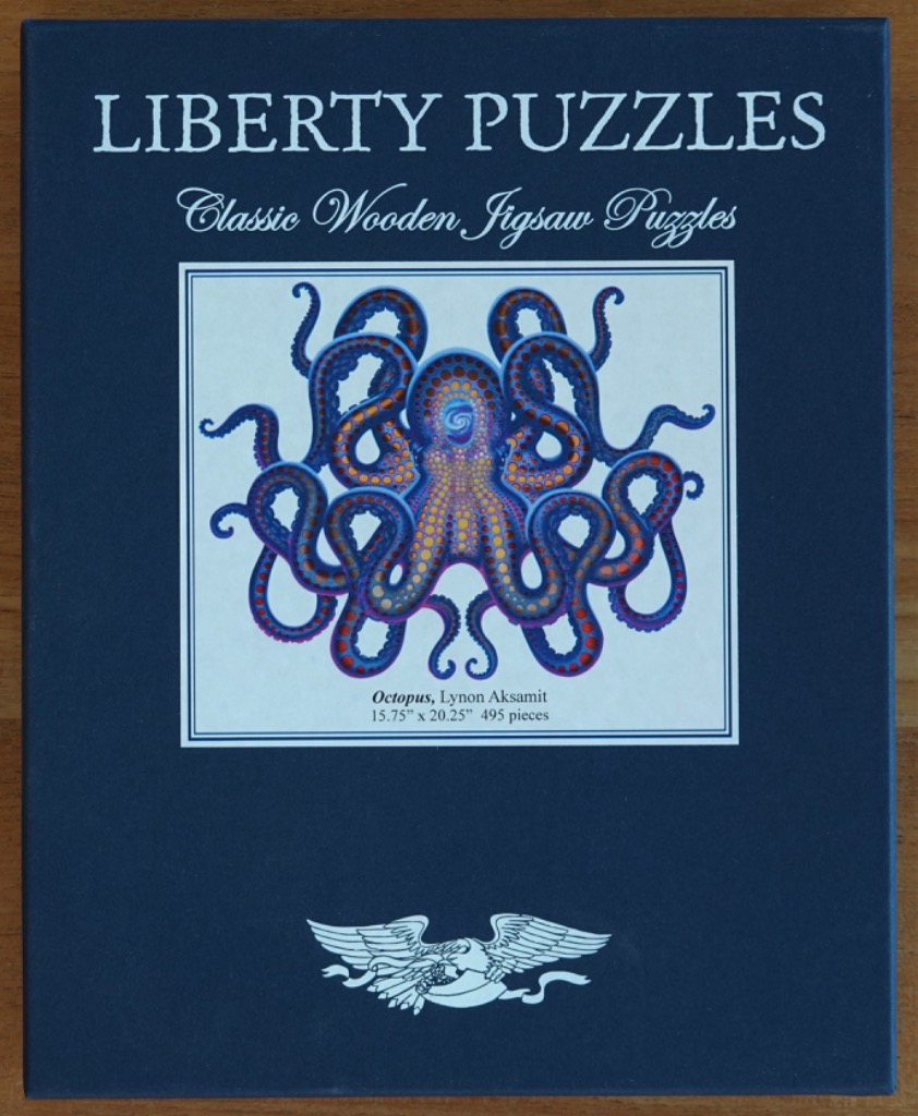 A stylized illustration of a symmetrical octopus against a white background featuring blue and orange patterns.