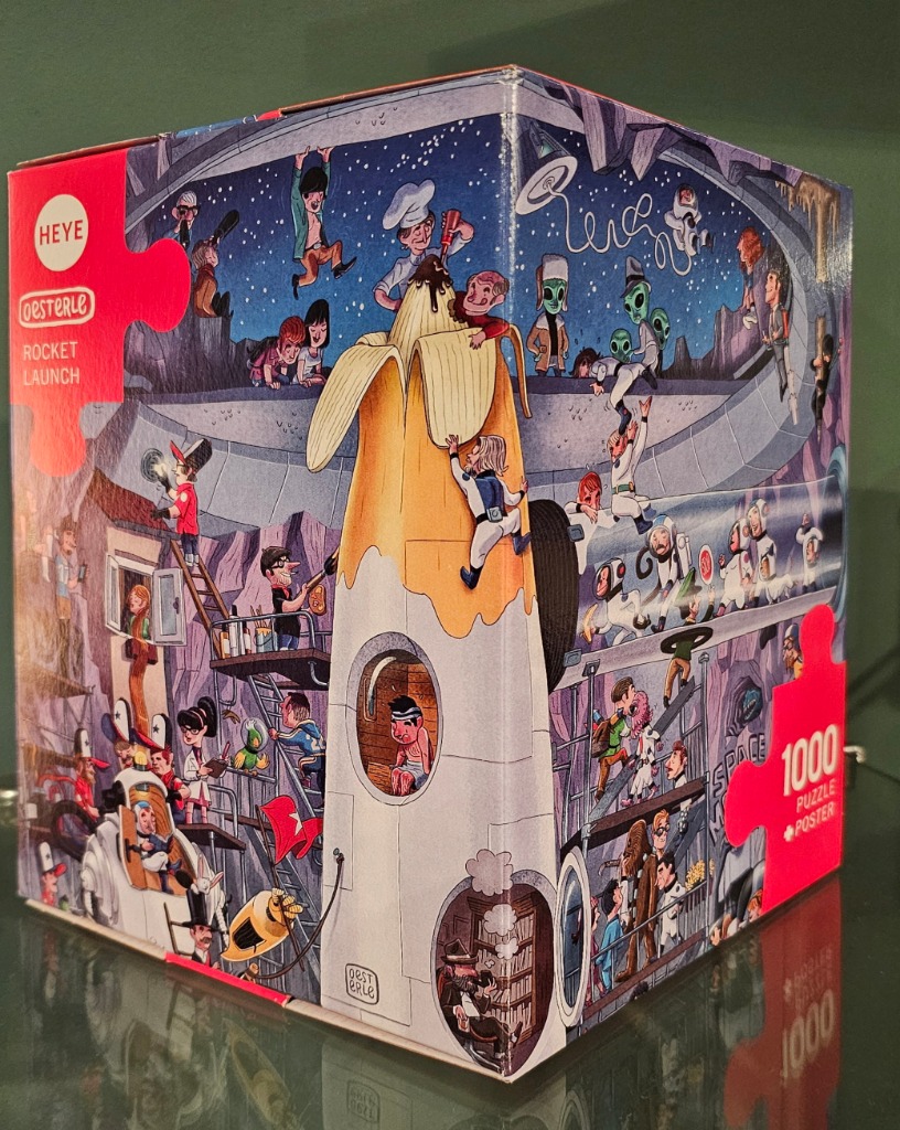 Cartoon illustration of a giant banana rocket being prepared by a busy crowd of diverse characters in a subterranean base