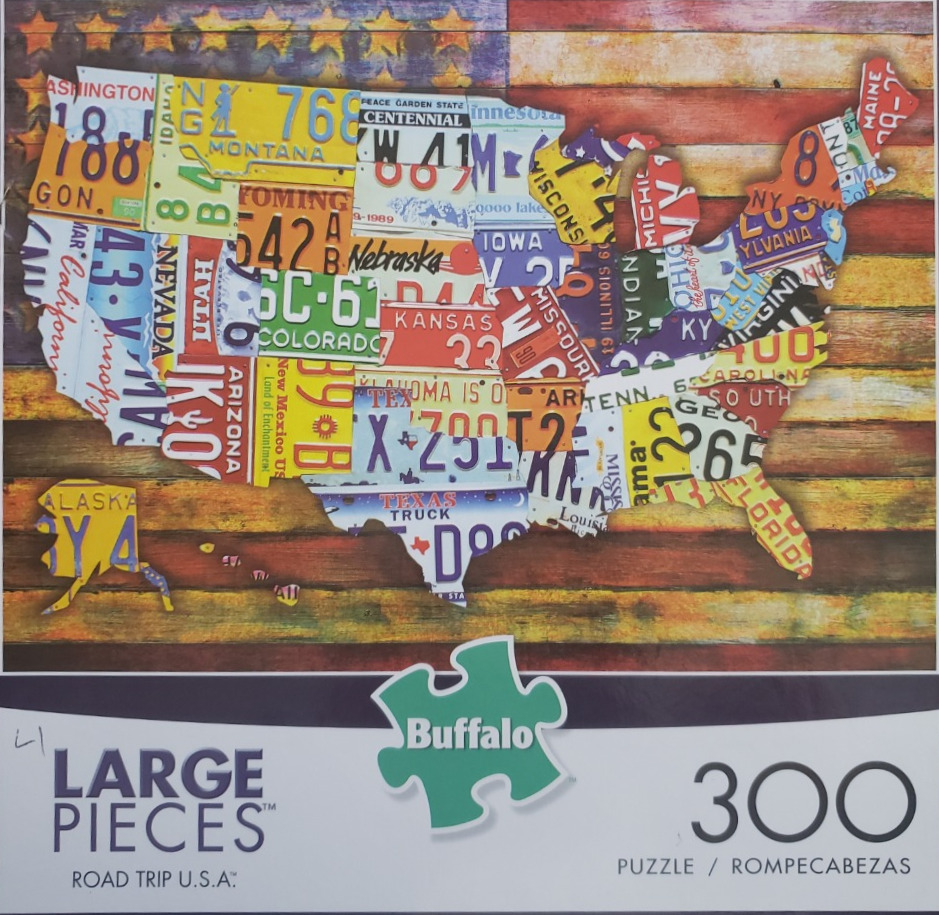 A collage in the shape of the United States map constructed from colorful vintage license plates over an American flag.