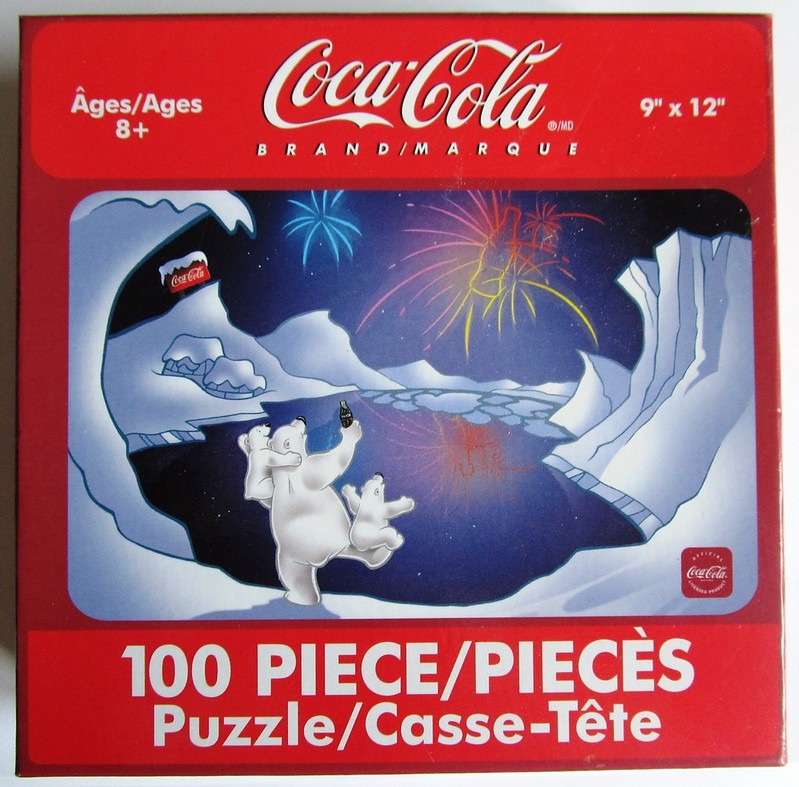 Illustration of polar bears watching fireworks over an arctic landscape with a Coca-Cola bottle.