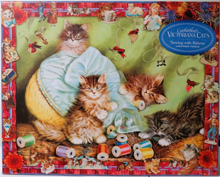 A Victorian-style illustration of a mother cat and kittens playing with sewing supplies.