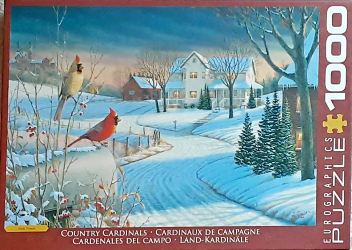 A winter landscape featuring two cardinals perched on a snowy fence with a farmhouse in the background.