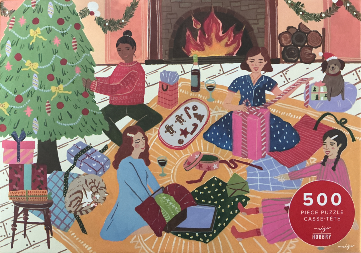 Four women and a dog sitting on a rug wrapping Christmas gifts in front of a fireplace.