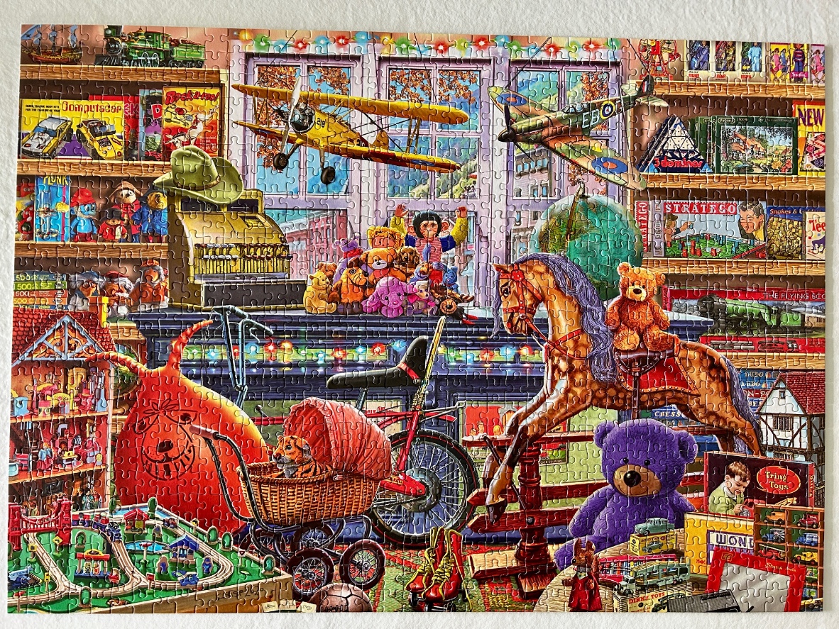 A nostalgic toy store interior filled with shelves of games, a rocking horse, a vintage stroller, and hanging airplanes.