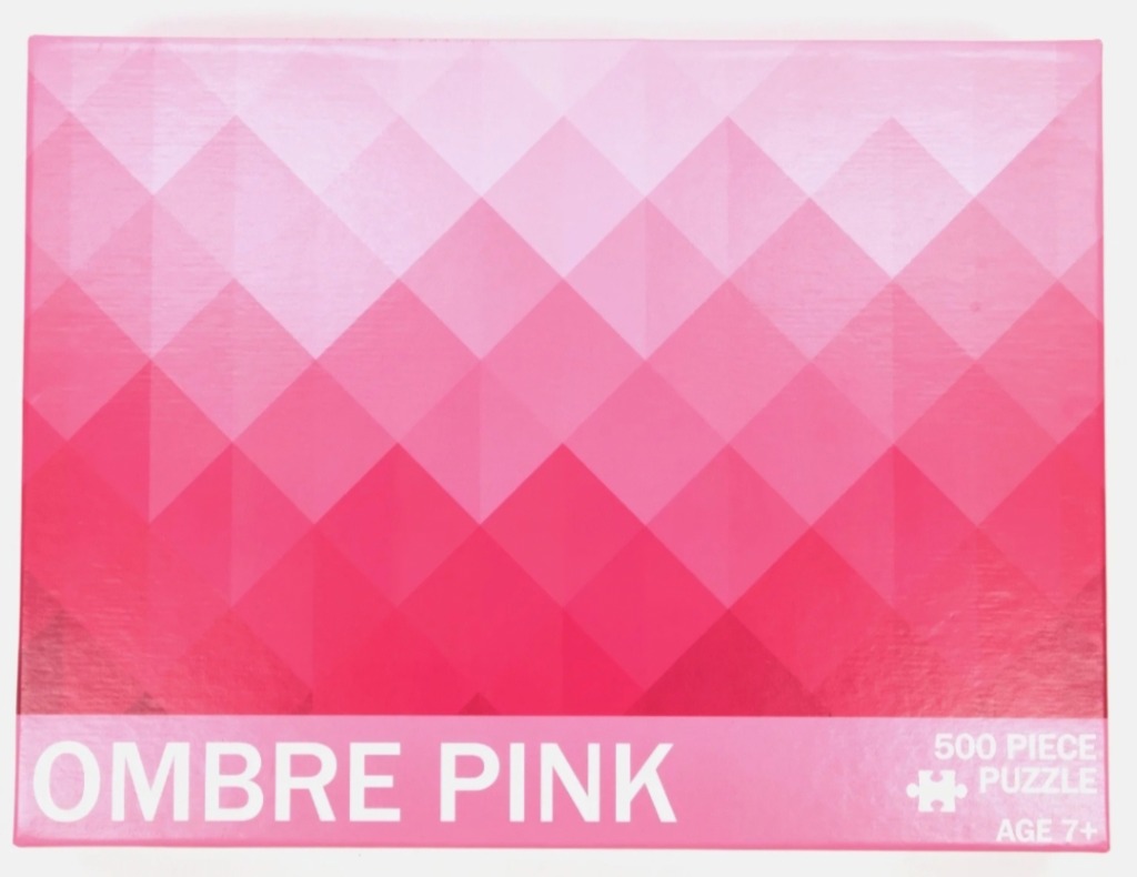 An abstract geometric pattern of diamond shapes in a pink ombre gradient.