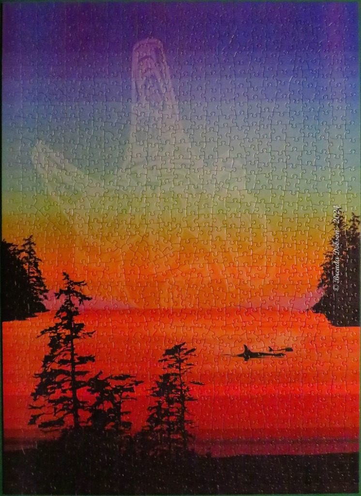 A silhouette of a kayaker on a vibrant sunset sea with a ghostly, towering rock formation in the sky.