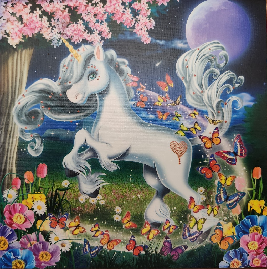 A whimsical white unicorn in a meadow filled with flowers, butterflies, and a full moon under a cherry blossom tree.
