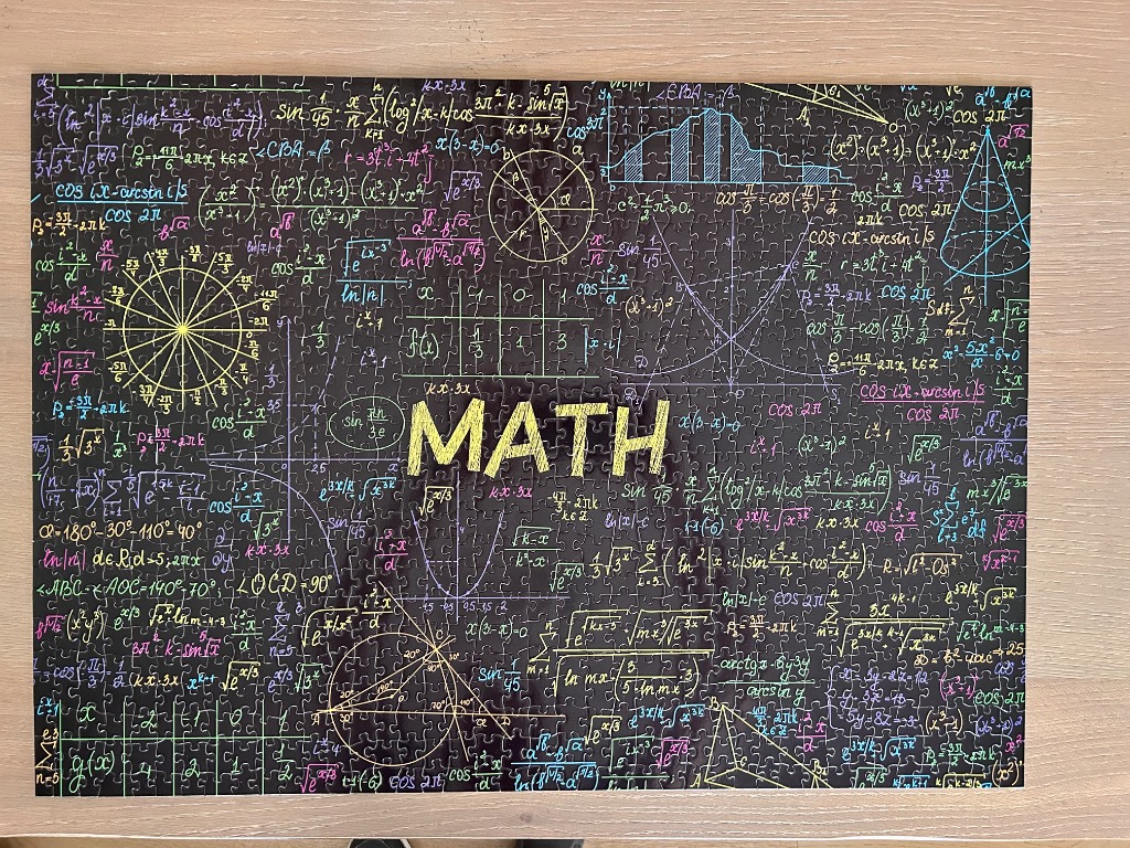 A black chalkboard background covered in various mathematical formulas, geometry diagrams, and the word MATH in yellow.