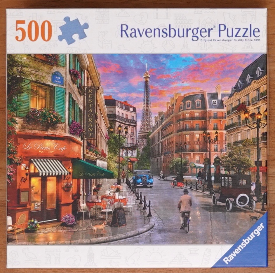 A romantic Parisian street scene at sunset featuring the Eiffel Tower and a sidewalk cafe.