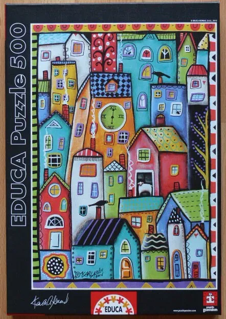 Whimsical folk art illustration of a dense, colorful village with stylized houses and patterned roofs.