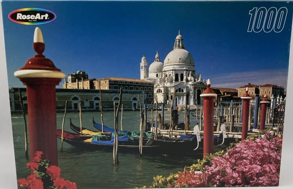 A view of the Basilica di Santa Maria della Salute in Venice across a canal with moored gondolas.