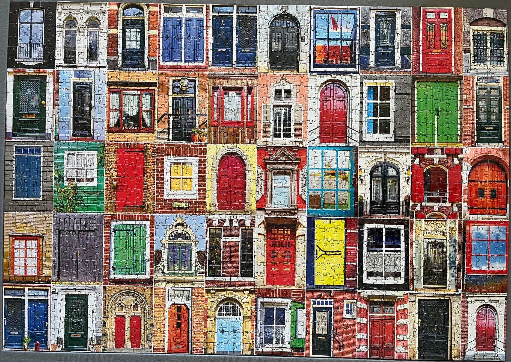 A collage of colourful European-style doors and windows arranged in a grid.