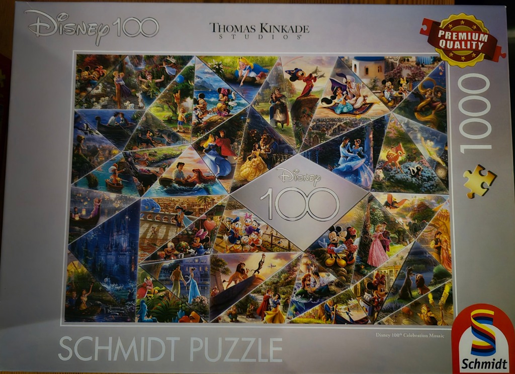 A mosaic art piece featuring various iconic animated Disney film scenes arranged in geometric triangular shards.