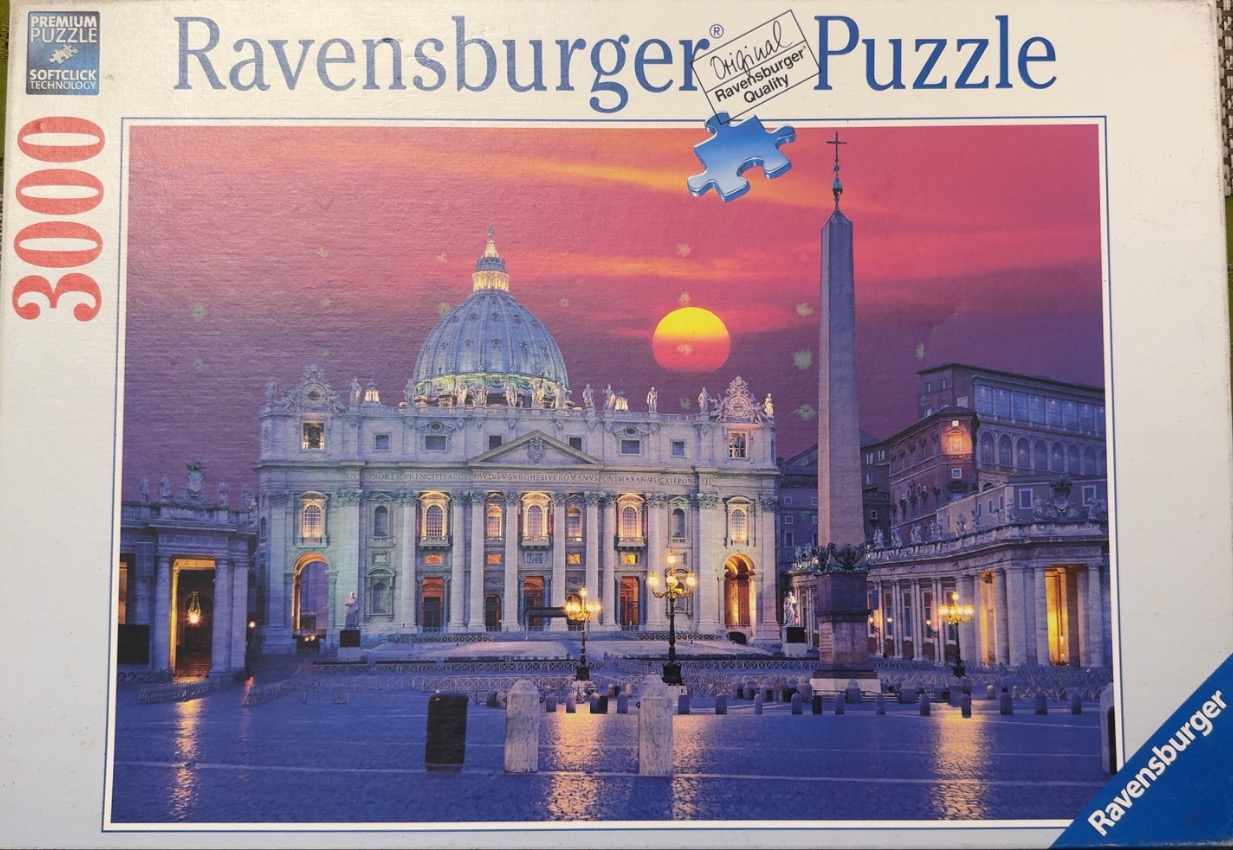 St. Peter's Basilica in Vatican City at twilight with a prominent obelisk and a vibrant sunset sky.
