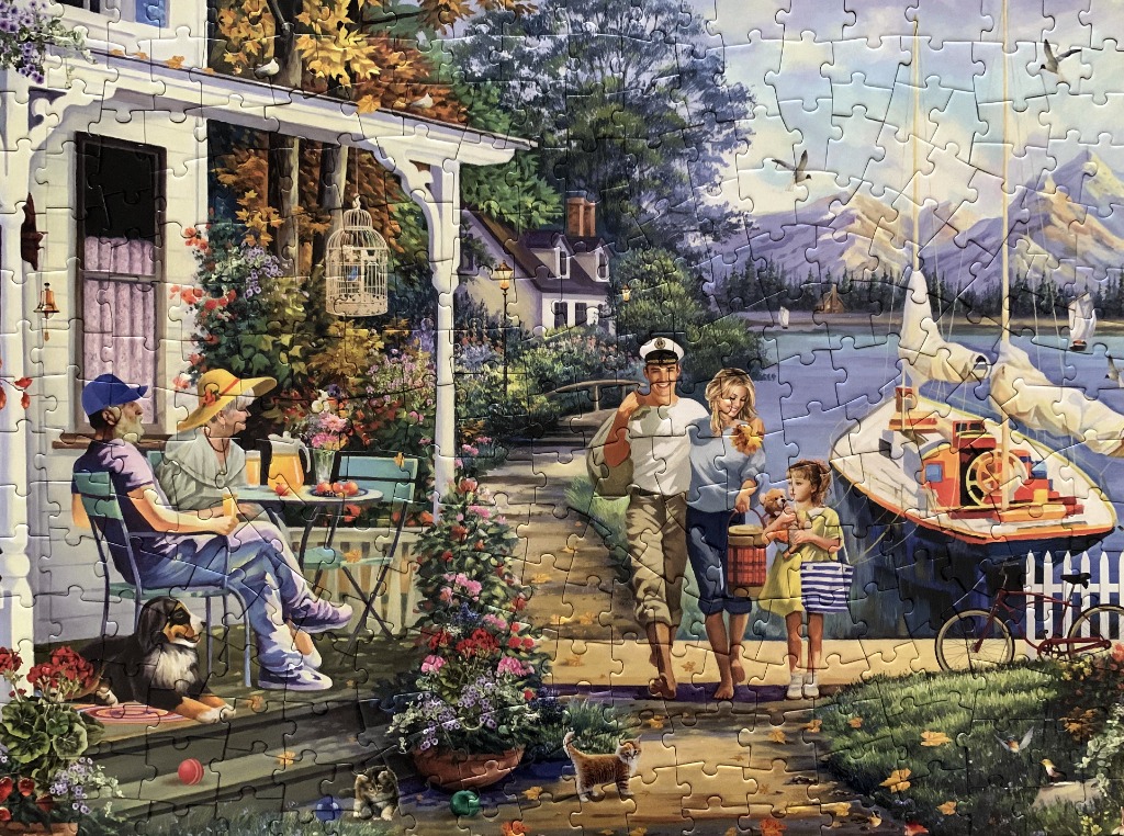 A peaceful lakeside scene featuring an elderly couple on a porch and a young family walking along a path by a sailboat.