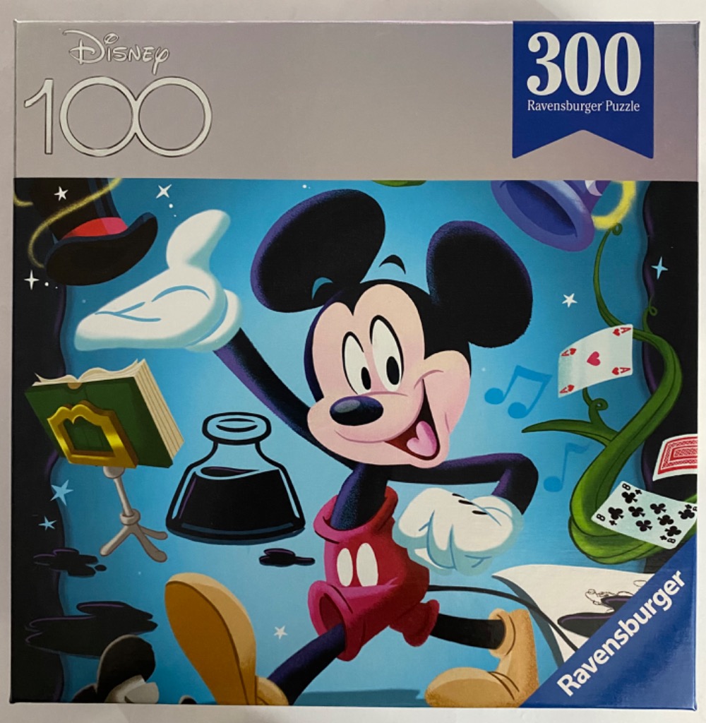 Mickey Mouse in a whimsical, magical setting surrounded by flying objects against a blue background.