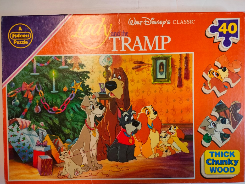 Animated scene of Lady, Tramp, and other dogs gathered near a Christmas tree
