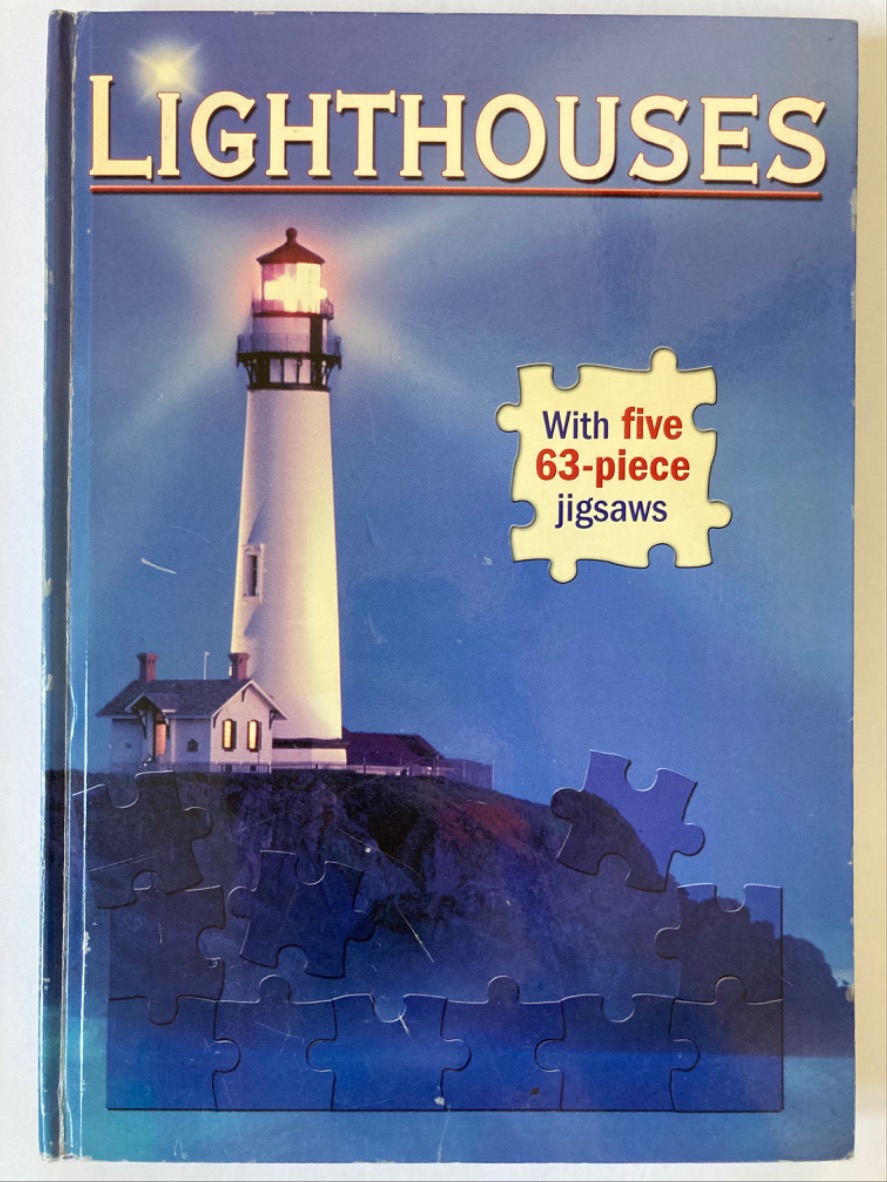 A lighthouse shining its beacon at dusk over a coastal cliffside.