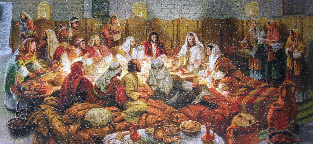 A painting of Jesus and his disciples sharing a meal in a dimly lit, rustic interior.