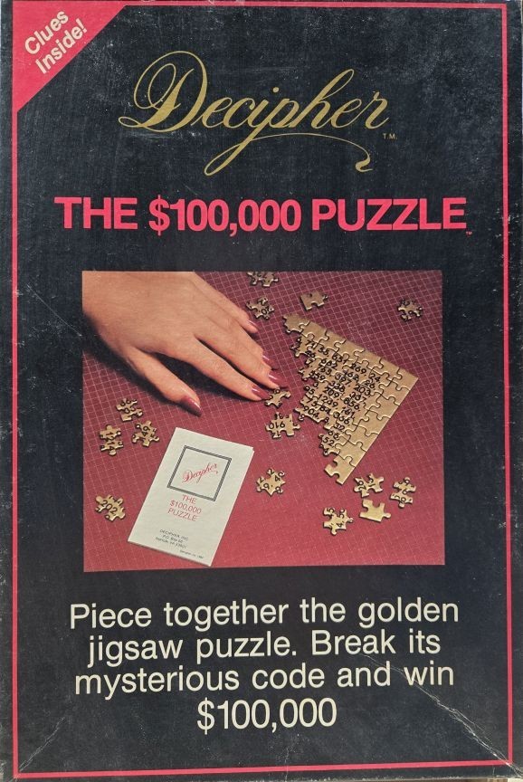 A hand assembling a golden jigsaw puzzle with numbers printed on the pieces on a red grid mat.