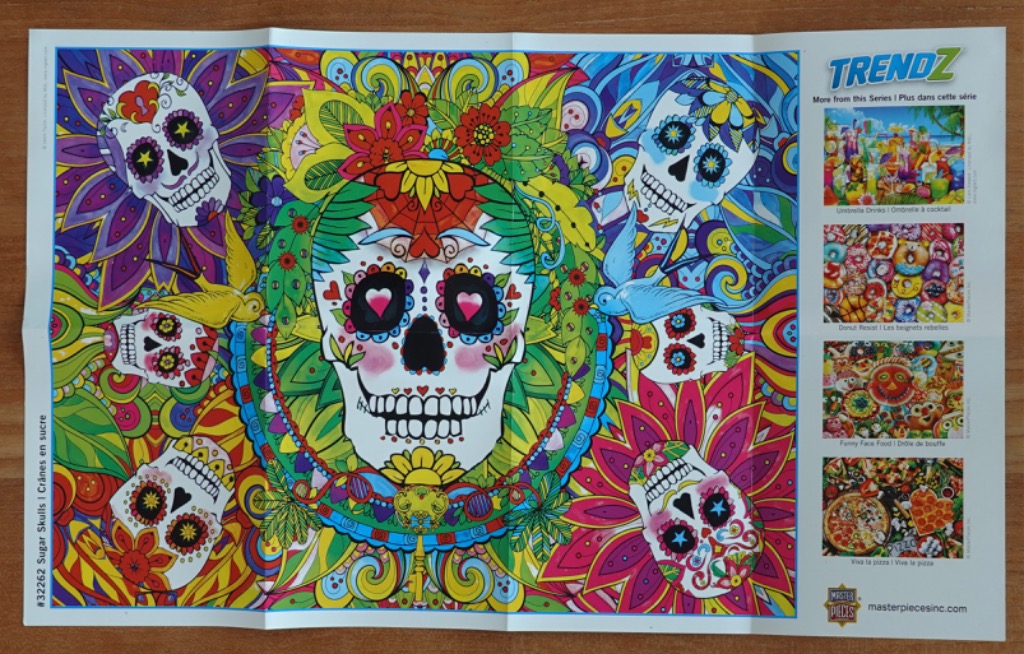 Vibrant, colorful Day of the Dead-style illustration featuring a central sugar skull surrounded by decorative patterns.