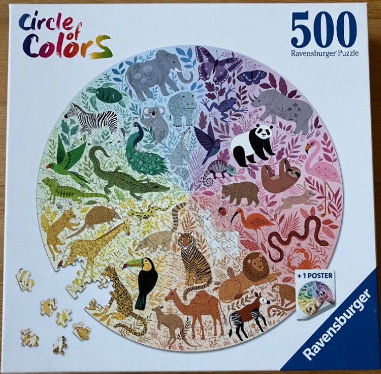 A circular arrangement of diverse animals colored according to a color wheel gradient on a white background.