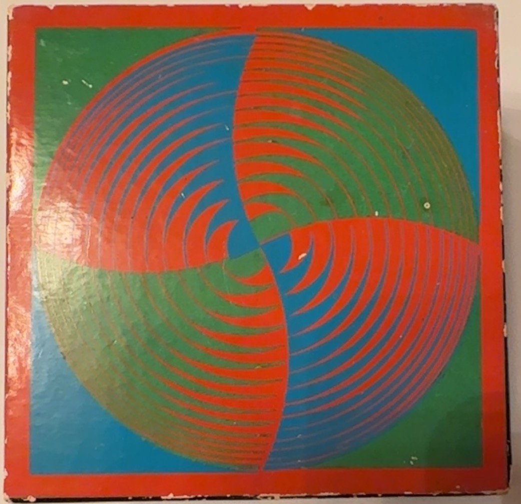 Op-art style illustration featuring a central circle with radiating, spiraling red, green, and blue arcs.