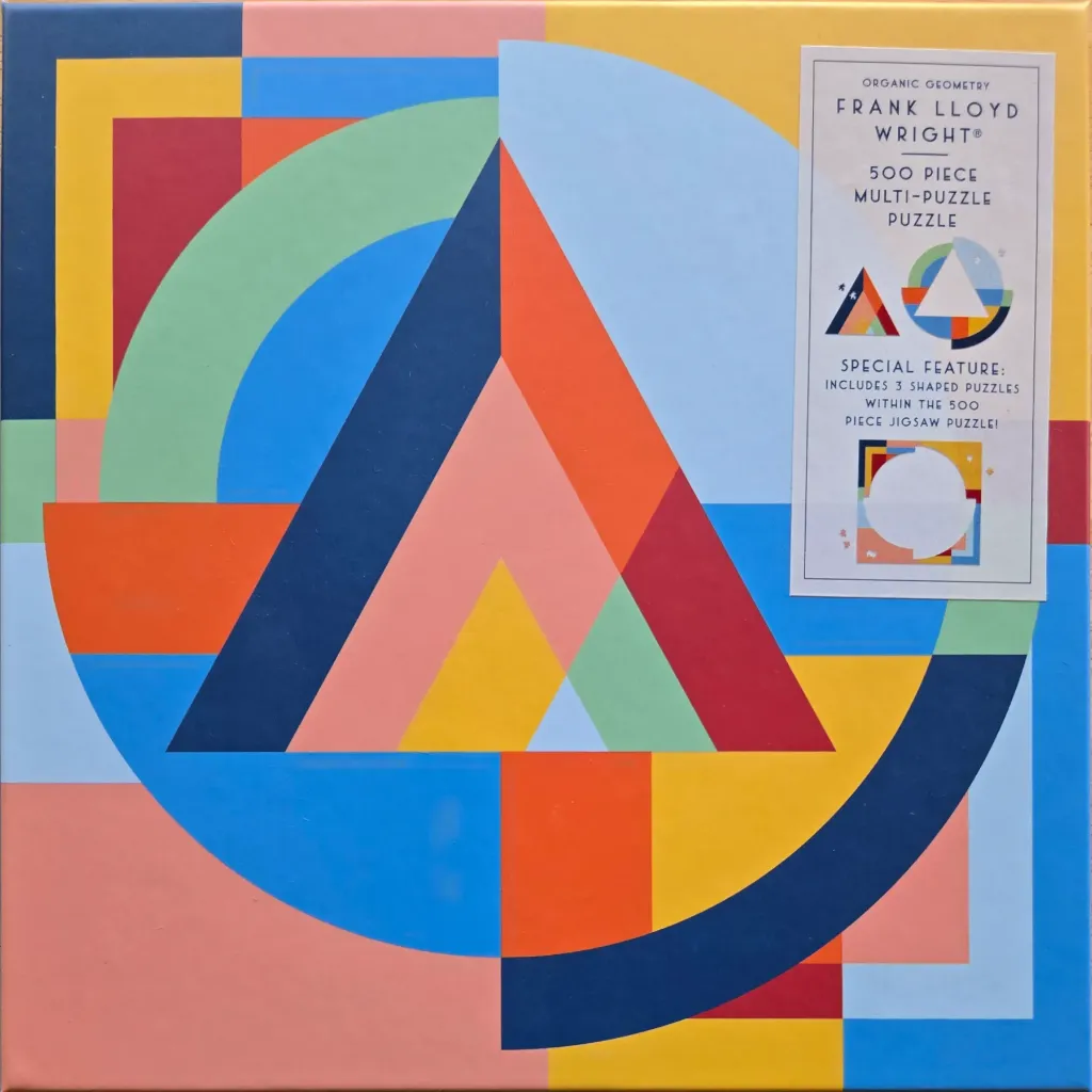 Abstract geometric composition of interlocking triangles and circles in primary and muted colours.
