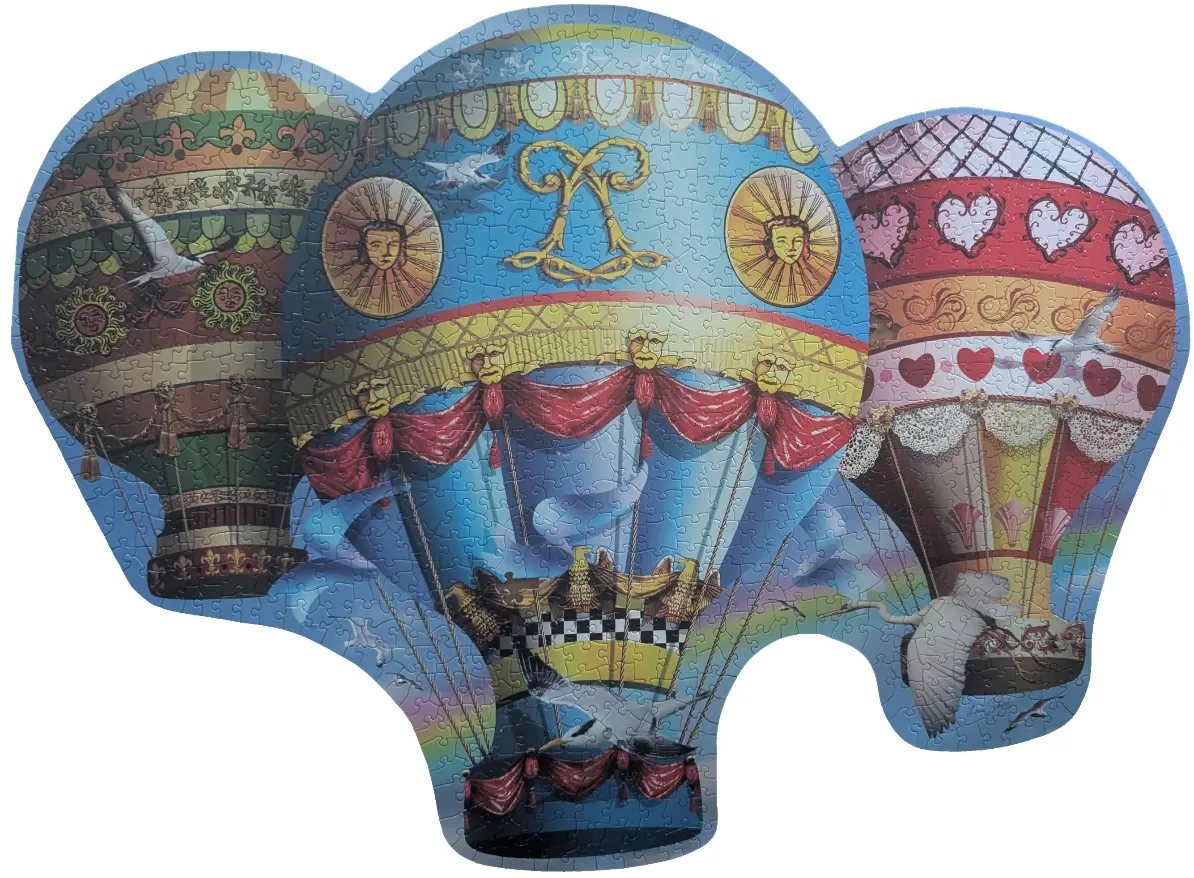 Three intricately decorated hot air balloons floating against a blue, cloud-filled sky.