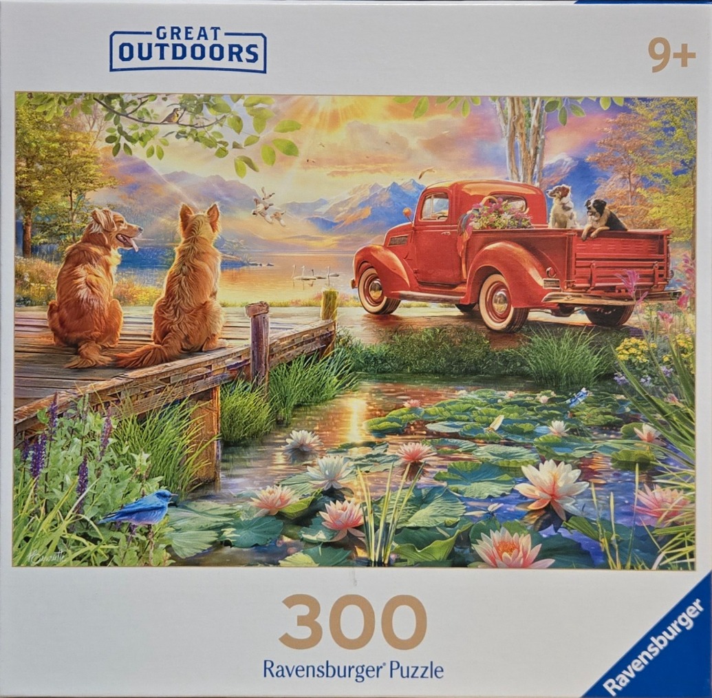 A scenic illustration featuring two dogs on a wooden dock overlooking a lake, a vintage red truck, and blooming water lilies.