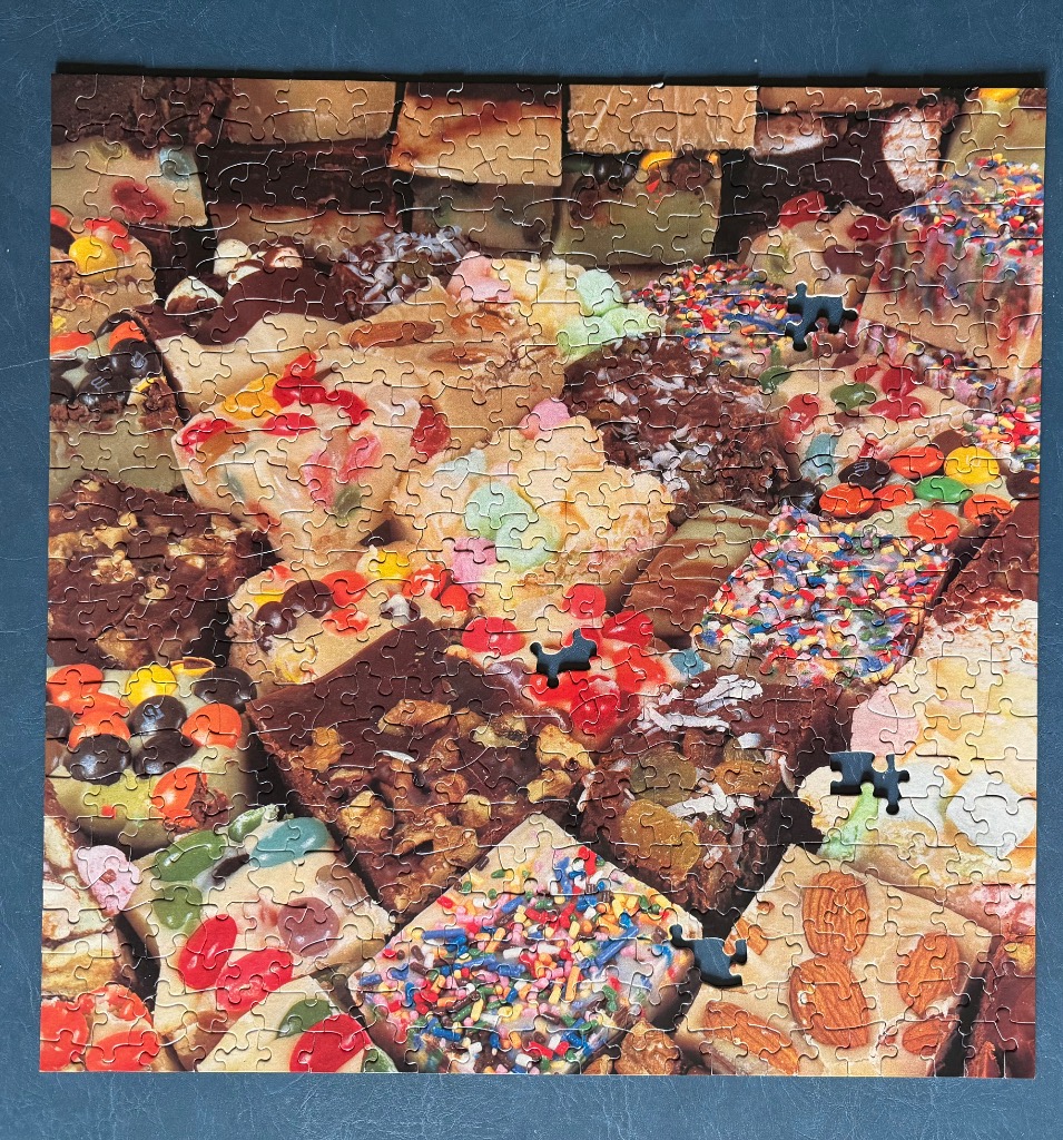 A close-up view of an assortment of colorful fudge and brownie squares.