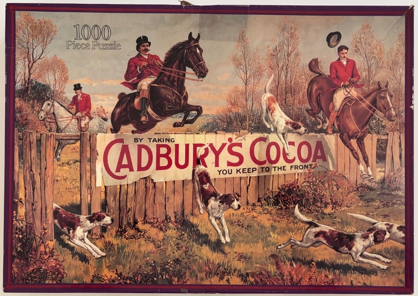 An illustration of a fox hunt with riders on horseback jumping over a wooden fence and dogs running in the foreground.