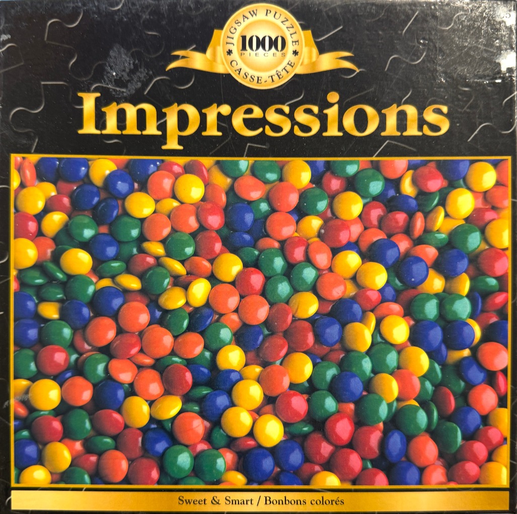 A close-up photograph of a large, dense pile of colorful, round chocolate-coated candies.