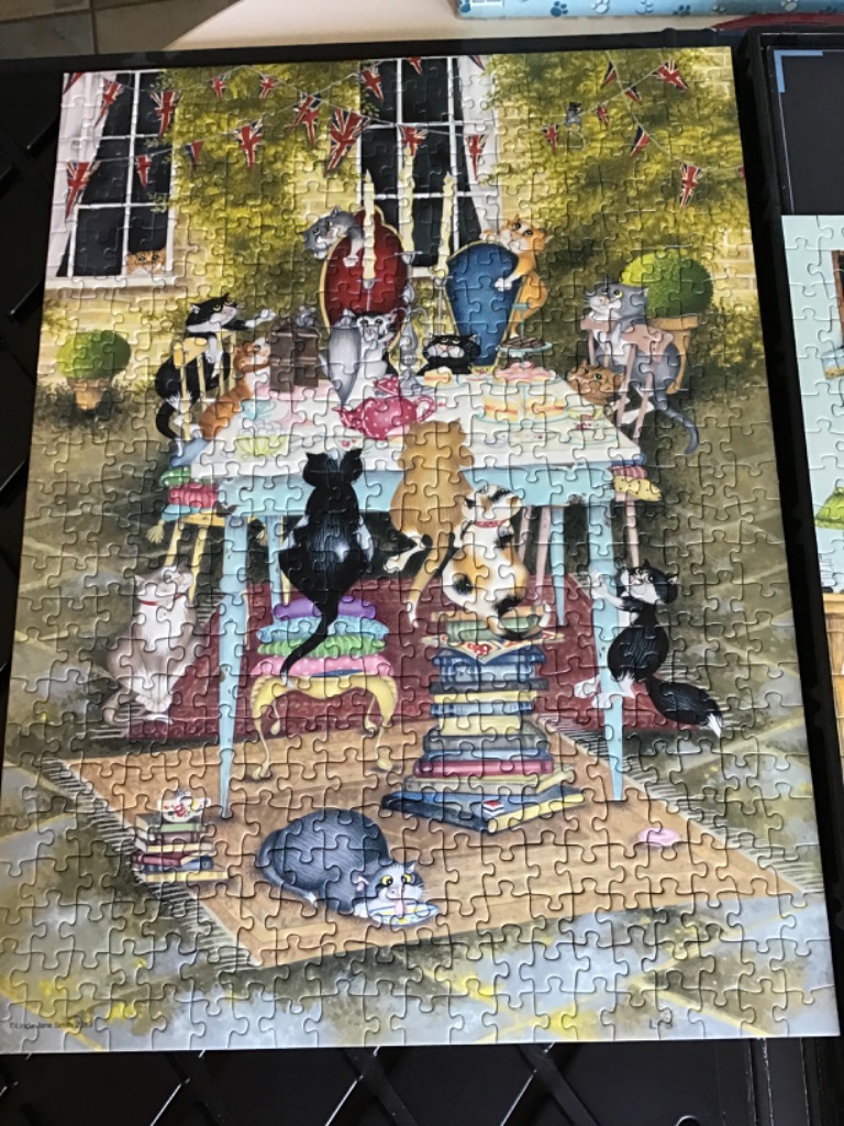 A whimsical illustration of many cats gathered for a tea party in a lush, green garden.