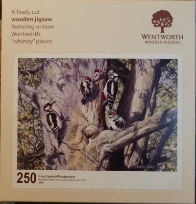 A painting of four great spotted woodpeckers on the trunk and branches of a large, textured tree.