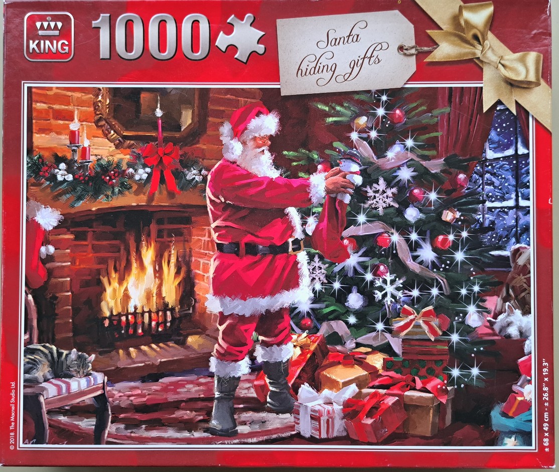Santa Claus placing a gift under a decorated Christmas tree next to a fireplace.