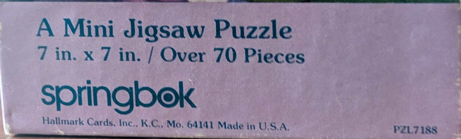 A Mini Jigsaw Puzzle, 7x7 inches, over 70 pieces. Teal text on purple.