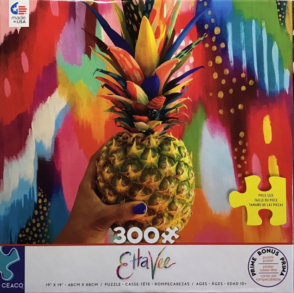 A hand holding a vibrant, artistic pineapple against an abstract, multicolored background.